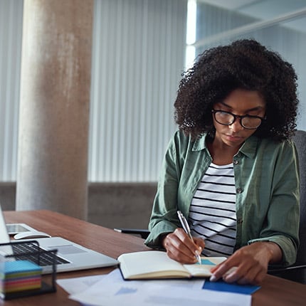A female expert working on SEO content as a part of website consulting firm methodology