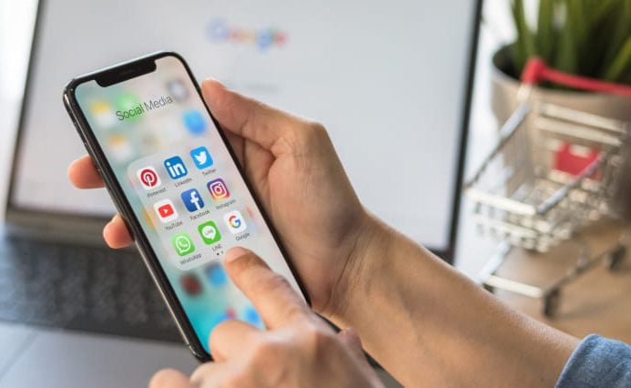 hotel-branding-agency-messaging Hotel branding expert searches apps on a phone