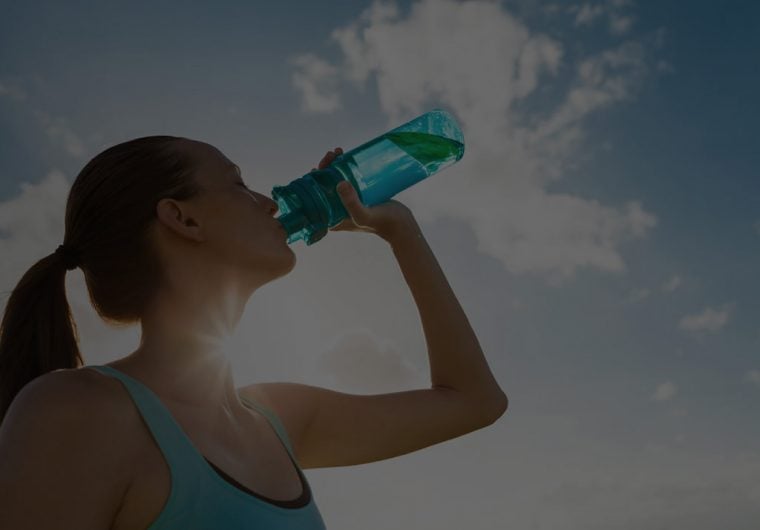 Newater-background A background image for NEWater of a woman drinking water in the sun