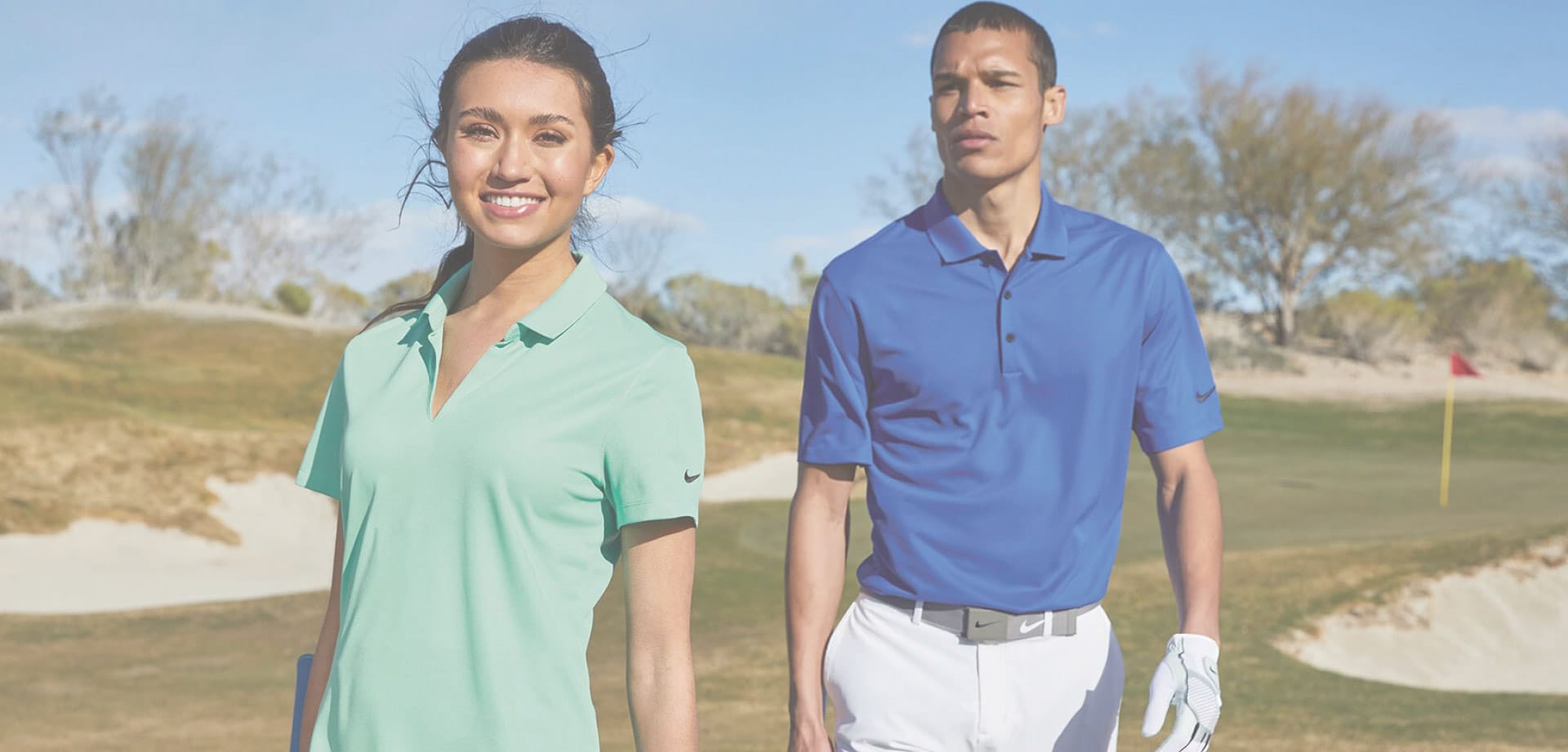 A young woman and a young man in yachtwear uniforms