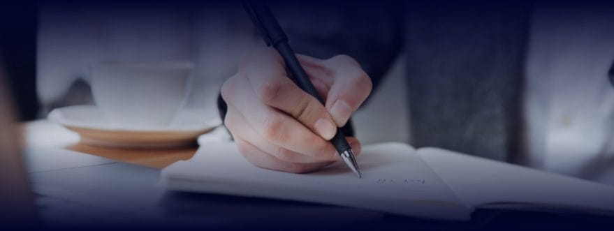 A person writing on a paper