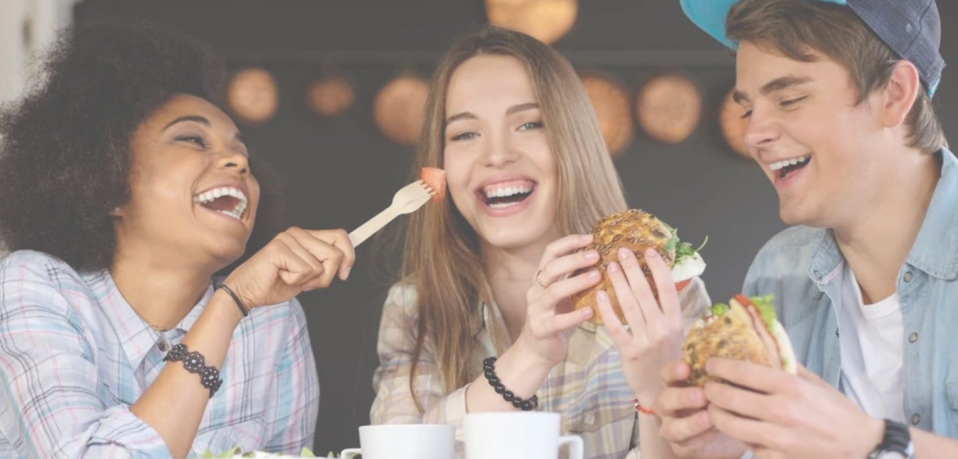 Image showing a group of people laughing while eating